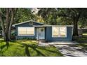 Charming single-story home with light blue siding and a well-maintained front yard at 1028 W Marjorie St, Lakeland, FL 33815