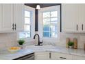 Bright kitchen features white cabinets, marble countertops and stainless steel appliances at 1028 W Marjorie St, Lakeland, FL 33815