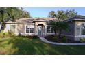 Well-maintained home with a landscaped front yard, inviting entryway, and lots of natural light at 10812 Versailles Blvd. Blvd, Clermont, FL 34711