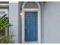 Inviting front door with decorative molding and a charming light fixture, creating a warm entrance at 120 Flatfish Ct, Kissimmee, FL 34759