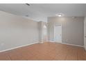 The living room boasts neutral walls, tile flooring, with an open archway leading to another space at 120 Flatfish Ct, Kissimmee, FL 34759