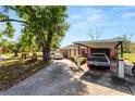 Charming property featuring a covered carport and mature tree offering ample shade at 1306 N Webster Ave, Lakeland, FL 33805