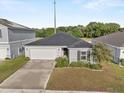 Beautiful home with a well-kept lawn, tidy landscaping, and an attached two-car garage at 1341 Mattie Pointe Blvd, Auburndale, FL 33823