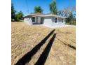Charming single-story home with a well-maintained lawn and neutral gray exterior at 1522 Kettles Ave, Lakeland, FL 33805