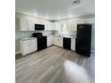 Modern kitchen featuring sleek black appliances, granite countertops, and updated white cabinetry at 1522 Kettles Ave, Lakeland, FL 33805