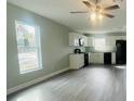 Bright, open kitchen with white cabinets, stainless steel appliances, and wood-look flooring at 1522 Kettles Ave, Lakeland, FL 33805