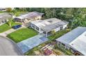 Charming home with a long driveway and lush green lawn, surrounded by mature trees and landscaping at 1610 Reynolds Rd # 50, Lakeland, FL 33801