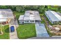 Beautiful home with well-manicured lawn, long driveway, and verdant landscaping from an aerial perspective at 1610 Reynolds Rd # 50, Lakeland, FL 33801
