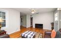 Bright living room featuring hardwood floors, a ceiling fan, and an open layout with ample space at 2104 W End Ave, Lakeland, FL 33803