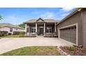 Charming home featuring a spacious front porch with classic columns and a two-car attached garage at 2569 Colonel Ford Dr, Lakeland, FL 33813