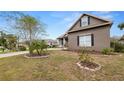 Well-maintained lawn with decorative rock and mature landscaping surrounding a stucco home at 2569 Colonel Ford Dr, Lakeland, FL 33813