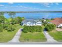 Aerial view of waterfront property with large home, lush landscaping, and access to a serene lake at 2653 State Road 557, Lake Alfred, FL 33850