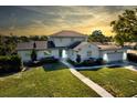 Charming two-story home with a well-maintained lawn, beautiful landscaping, and attached two-car garage at 2816 Fairmount Ave, Lakeland, FL 33803