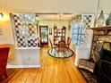 Cozy dining room with hardwood floors, chandelier, and adjacent access to other living areas at 302 Luna Rd, Auburndale, FL 33823
