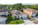 Aerial shot of a single Gathering home, showcasing the manicured lawn and surrounding neighborhood at 307 Balmoral Ct, Davenport, FL 33896