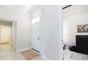 Bright entryway featuring neutral tile flooring, white walls, and direct access to bedroom/office at 3071 Shoal Creek Village Dr, Lakeland, FL 33803