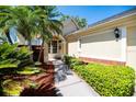 Inviting home exterior with lush landscaping and a welcoming front entrance with a decorative wreath at 3071 Shoal Creek Village Dr, Lakeland, FL 33803
