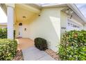 Close-up of charming home exterior with a covered porch, decorative plants, and an attached garage at 3080 Westmoreland Dr, Lakeland, FL 33810