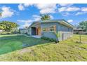 Modern single-story home with natural wood accents, tidy landscaping and a well maintained lawn at 3134 Hilltop S Ave, Lakeland, FL 33803