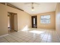 Bright living room with large window, ceiling fan, and tiled floor at 404 Red Hawk Loop, Winter Haven, FL 33880