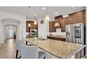 Bright kitchen featuring granite countertops, stainless steel appliances, and a breakfast bar with seating at 4232 Prima Lago Dr, Lakeland, FL 33810