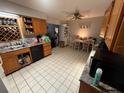 Well-lit kitchen featuring a tile floor, ample cabinet space, and modern appliances at 460 W Pierce St, Lake Alfred, FL 33850