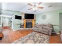 Cozy living room features a stone fireplace, wood floors, and comfortable seating at 530 Heather Ct, Bartow, FL 33830