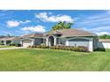 A single-story home is set on a well-kept lawn with manicured shrubbery at 5638 Bloomfield Blvd, Lakeland, FL 33810