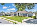 A single-story home with manicured landscaping and a paved driveway at 5638 Bloomfield Blvd, Lakeland, FL 33810