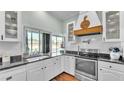 Bright kitchen with stainless steel appliances, white cabinetry, and a window overlooking the pool at 5638 Bloomfield Blvd, Lakeland, FL 33810