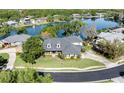 Aerial view of a stunning home on a lush lot with lake views and a circular driveway at 5789 Lake Victoria Dr, Lakeland, FL 33813