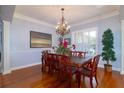 Formal dining room with chandelier, large table, and detailed molding at 5789 Lake Victoria Dr, Lakeland, FL 33813