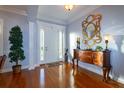 Elegant foyer with hardwood floors, decorative mirror, and classic trim work at 5789 Lake Victoria Dr, Lakeland, FL 33813