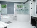 Beautiful bathroom featuring a glass shower and a separate soaking tub at 6470 Ashley Dr, Lakeland, FL 33813