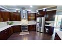 Modern kitchen boasts sleek dark wood cabinetry and stainless steel appliances at 6470 Ashley Dr, Lakeland, FL 33813