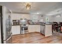 Bright kitchen with stainless steel appliances and wood-look flooring at 900 Saddlewood Blvd, Lakeland, FL 33809