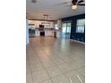 Open-concept living space featuring tile floors and seamless transition to a modern kitchen at 1018 Roberta Rd, Lake Wales, FL 33853