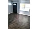 Bright living room with sleek flooring and ample natural light from the window at 1024 31St Nw St, Winter Haven, FL 33881