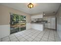 Bright kitchen with white cabinets, appliances, breakfast bar and sliding glass doors to the outside, offering a functional layout at 1116 Durham Dr, Lakeland, FL 33809