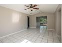 Bright living room featuring tile floors, neutral paint, and large windows letting in plenty of natural light and a ceiling fan at 1116 Durham Dr, Lakeland, FL 33809