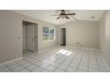 Sun-filled living room boasts tile flooring and large windows, creating a bright and welcoming space with a ceiling fan at 1116 Durham Dr, Lakeland, FL 33809