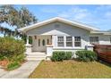 Inviting front entrance with a decorative glass door, manicured shrubs, and a well-maintained lawn at 1390 S 1St Ave, Bartow, FL 33830