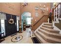 Inviting foyer with a decorative tile floor, staircase, and plenty of natural light at 181 James Cir, Lake Alfred, FL 33850