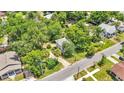 Aerial view of a home nestled among mature trees, showcasing its location in a residential neighborhood at 205 W Belmar St, Lakeland, FL 33803