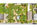 Aerial view of the property, showcasing the house, lush greenery, and the outline of the lot at 205 W Belmar St, Lakeland, FL 33803