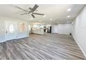 Open-concept living space features vinyl flooring and a view into the modern kitchen at 3335 Wren Ln, Mulberry, FL 33860