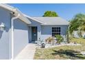 Inviting front entrance with a decorative wreath and beautiful landscaping including white rocks and green plants at 3427 Imperial Manor Way, Mulberry, FL 33860