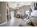 Spacious living room featuring luxury vinyl floors, neutral paint, comfortable seating, and sliding doors to the lanai at 3427 Imperial Manor Way, Mulberry, FL 33860