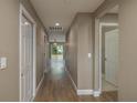 Hallway with wood flooring leading to the living area and bedrooms at 41 Powell Rd, Winter Haven, FL 33880