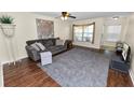 Inviting living room boasts hardwood floors, ceiling fan, and plentiful natural light at 5407 River Rock Rd # 5407, Lakeland, FL 33809